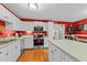 A well-lit kitchen with stainless steel appliances and white cabinetry at 2825 Alder Ridge Ln, Raleigh, NC 27603