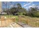 Spacious backyard features a wooden deck, lush green grass, and a peaceful fire pit area at 297 Lane Store Rd, Franklinton, NC 27525