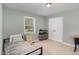 Cozy bedroom featuring a comfortable twin bed, natural light, and a neutral color scheme at 297 Lane Store Rd, Franklinton, NC 27525