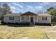 Charming single-story home with a welcoming front porch and well-maintained lawn at 297 Lane Store Rd, Franklinton, NC 27525