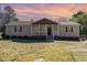 Charming single-story home with a cozy front porch and well-maintained lawn at 297 Lane Store Rd, Franklinton, NC 27525