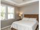 Serene bedroom features a queen-sized bed, soft lighting, and two bright windows at 3037 Willow Ranch Dr, Fuquay Varina, NC 27526