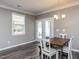 Cozy dining area with a rustic wooden table, white chairs, and a view to the patio at 3037 Willow Ranch Dr, Fuquay Varina, NC 27526