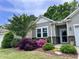 Charming home with gray siding, stone accents, and lush landscaping with blooming flowers at 3037 Willow Ranch Dr, Fuquay Varina, NC 27526