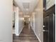 Inviting hallway with hardwood floors and neutral paint, leading to various rooms at 3037 Willow Ranch Dr, Fuquay Varina, NC 27526
