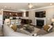 Open-concept living area with a fireplace, mounted TV, kitchen, and sectional sofa at 3037 Willow Ranch Dr, Fuquay Varina, NC 27526