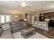 Open-concept living room featuring a kitchen, dining area, and a comfortable gray sectional at 3037 Willow Ranch Dr, Fuquay Varina, NC 27526
