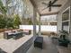 Covered patio with comfortable seating, a fan, and a view of the landscaped backyard at 3037 Willow Ranch Dr, Fuquay Varina, NC 27526