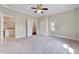 Spacious bedroom with carpet, windows, and multiple doorways at 309 W Parrish Dr, Benson, NC 27504