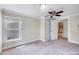 Bright bedroom featuring a ceiling fan, carpeted floors, and white trim throughout at 309 W Parrish Dr, Benson, NC 27504
