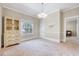 Bright dining room with decorative chandelier, picture window, and neutral paint at 309 W Parrish Dr, Benson, NC 27504