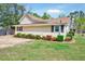 Side view of a single-story home with landscaping and a well-manicured lawn at 309 W Parrish Dr, Benson, NC 27504