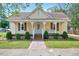 Charming home featuring a welcoming front porch, complemented by neat landscaping and a brick walkway at 309 W Parrish Dr, Benson, NC 27504