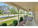 Inviting porch with ornate railings and a seating swing, overlooking a charming neighborhood street at 309 W Parrish Dr, Benson, NC 27504