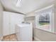 Laundry room with window, washer, dryer and built in storage at 309 W Parrish Dr, Benson, NC 27504