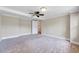 Spacious main bedroom with carpeting, neutral paint colors, fan and lots of natural light at 309 W Parrish Dr, Benson, NC 27504