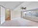 Spacious main bedroom with carpeting, neutral paint colors, fan and lots of natural light at 309 W Parrish Dr, Benson, NC 27504