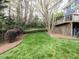 Expansive backyard with manicured lawn and mature trees, offering privacy and space at 3100 Anderson Dr, Raleigh, NC 27609