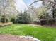 Well-maintained backyard features a lush lawn, landscaping, and privacy fence at 3100 Anderson Dr, Raleigh, NC 27609