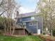 Charming backyard with a deck, fenced yard, and access to the home's lower level at 3100 Anderson Dr, Raleigh, NC 27609