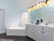 Bathroom featuring a soaking tub, double vanity, and ample counter space at 3100 Anderson Dr, Raleigh, NC 27609