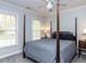 Sunlit bedroom with windows and a four-poster bed, creating a relaxing space at 3100 Anderson Dr, Raleigh, NC 27609