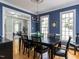 Dining room featuring a large window, hardwood flooring, and modern chandelier at 3100 Anderson Dr, Raleigh, NC 27609