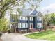 Charming two-story home with blue siding, white shutters, and a well-manicured front lawn at 3100 Anderson Dr, Raleigh, NC 27609