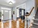 Inviting foyer with hardwood floors, a staircase, and view to dining room at 3100 Anderson Dr, Raleigh, NC 27609