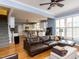 Open-concept living room with hardwood floors and easy access to a modern, white kitchen at 3100 Anderson Dr, Raleigh, NC 27609
