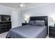 Cozy main bedroom featuring a ceiling fan, black furnishings, and neutral paint at 3100 Anderson Dr, Raleigh, NC 27609