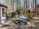 Wooded back yard featuring a covered greenhouse, pond, and playground at 311 Lilliput Ln, Wake Forest, NC 27587