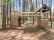 Fun backyard treehouse featuring a connected tower, covered area, and open play space surrounded by trees at 311 Lilliput Ln, Wake Forest, NC 27587