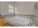 Soaking tub in a bathroom with tiled surround offering a relaxing retreat at 311 Lilliput Ln, Wake Forest, NC 27587