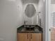 Half bathroom featuring a vanity with granite top, vessel sink, and brushed metal faucet at 311 Lilliput Ln, Wake Forest, NC 27587