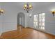 Formal dining room with hardwood floors, crown moulding, and stylish chandelier at 311 Lilliput Ln, Wake Forest, NC 27587