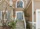 This beautiful entrance features stone steps, glass paned windows and wood accents at 311 Lilliput Ln, Wake Forest, NC 27587