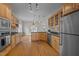 Kitchen featuring stainless appliances, hardwood floors, and eat-in area at 311 Lilliput Ln, Wake Forest, NC 27587