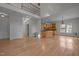 Open living space with hardwood floors, second floor balcony, and access to kitchen at 311 Lilliput Ln, Wake Forest, NC 27587