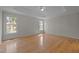 Bright main bedroom features a tray ceiling, hardwood floors, and windows overlooking the lush yard at 311 Lilliput Ln, Wake Forest, NC 27587