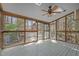 Screened in porch with skylights and a ceiling fan overlooking the back yard and playground at 311 Lilliput Ln, Wake Forest, NC 27587