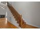 Staircase with wood stairs, decorative wrought iron railing, and hardwood floors at 311 Lilliput Ln, Wake Forest, NC 27587