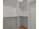 Walk-in closet with built-in shelving and hardwood floors for an organized storage solution at 311 Lilliput Ln, Wake Forest, NC 27587