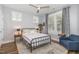 Cozy bedroom with a ceiling fan, bedside lamps, and natural light at 332 Tumbling River Dr, Wendell, NC 27591