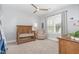 Cozy Bedroom with a wooden crib, rocking chair, and ample natural light from large windows at 332 Tumbling River Dr, Wendell, NC 27591