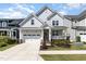 Charming two-story home with a well-manicured lawn and attached garage at 332 Tumbling River Dr, Wendell, NC 27591