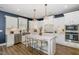 Modern kitchen features stainless steel appliances, a center island, and ample cabinet space at 332 Tumbling River Dr, Wendell, NC 27591
