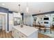 Open concept kitchen area with a center island and view into the dining and living rooms at 332 Tumbling River Dr, Wendell, NC 27591