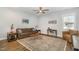 Comfortable living room with hardwood floors, ceiling fan, and neutral color palette for relaxation at 332 Tumbling River Dr, Wendell, NC 27591