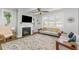 Bright living room with a fireplace, large windows, and elegant furniture at 332 Tumbling River Dr, Wendell, NC 27591
